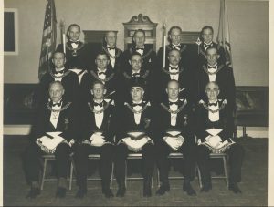 Masons sitting and standing for a group picture in the lodge circa 1950.