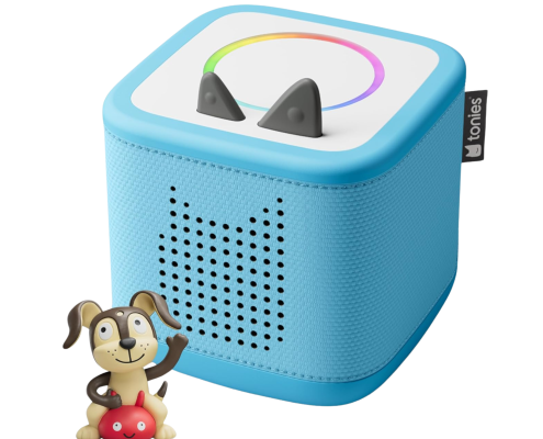 A blue audio player shaped like a cube with cat ear-like buttons, a rainbow LED ring, and a speaker grille. A small dog figurine sits beside it, possibly used to control or interact with the device.